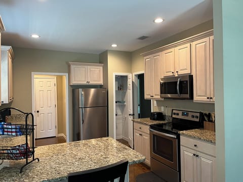 Kitchen has granite countertops, pots & pans, cooking utensils & dishwasher 