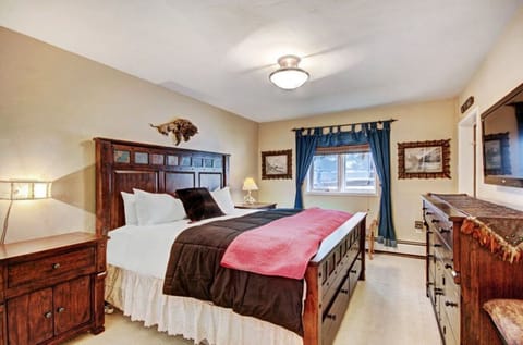 Relax in the cozy bedroom featuring a comfortable queen-sized bed, soft linens, and a private balcony offering a tranquil view, perfect for morning coffee or evening relaxation.
