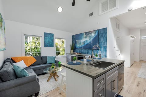 Natural light from windows & skylights enhance bar seating, living room