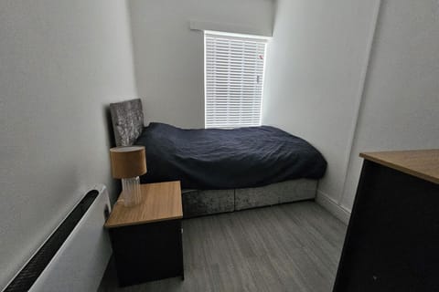 This comfortable room offers a comfortable bed with soft linens and warm lighting, creating a peaceful atmosphere. 