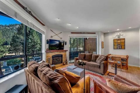 Living Room: Large windows w/mountain views, 2 couches, queen Murphy bed, 46” TV, gas fireplace