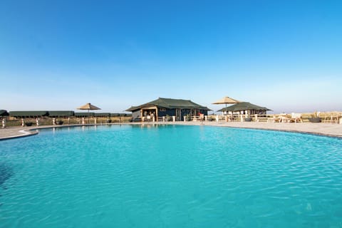 Outdoor pool, open 6:00 AM to 7:00 PM, pool umbrellas