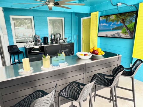 Sip cocktails in style at our luxury poolside bar, featuring a full refrigerator and freezer, with seating for up to eight guests.