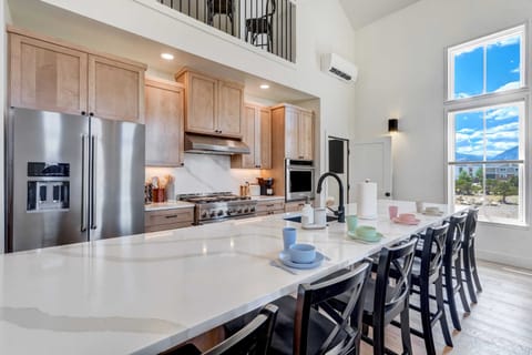 Modern kitchen with high-end appliances, large island, and stunning views.