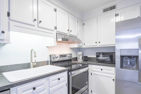 The Blue Oyster features a spacious kitchen with white cabinetry and stainless steel appliances.
