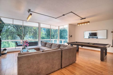 Large living area with TV, terrace access, and sofa bed.