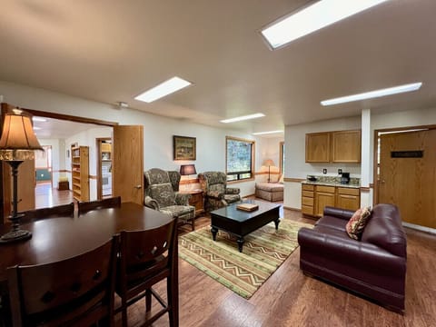 Second living room with cozy seating and a game table that seats 4