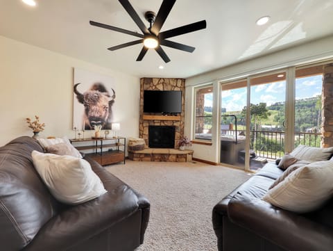 View of Great Room Overlooking Brian Head Pond and Private Deck with Jacuzzi.  54" Smart TV, Natural Gas Fireplace