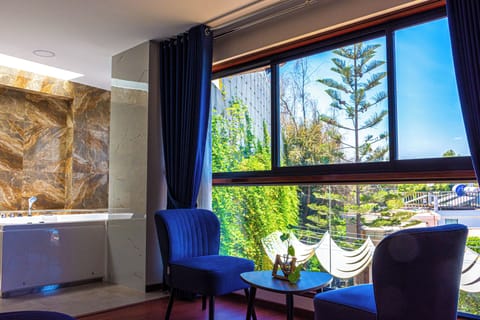 Deluxe Suite, Courtyard View | Minibar, in-room safe, individually decorated, desk