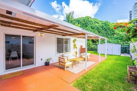 "Step outside to your private oasis! 🌿 Our covered patio with comfortable outdoor seating is the perfect spot for morning coffee or evening drinks. Enjoy the lush yard in this serene vacation rental retreat."