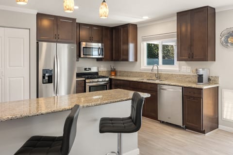 A fully equipped kitchen with granite counters and bar seating for quick breakfasts.