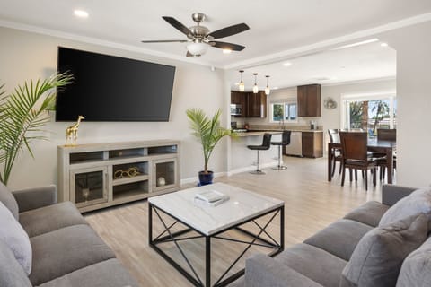 An open living room with plenty of seating and a big TV for movie nights in.