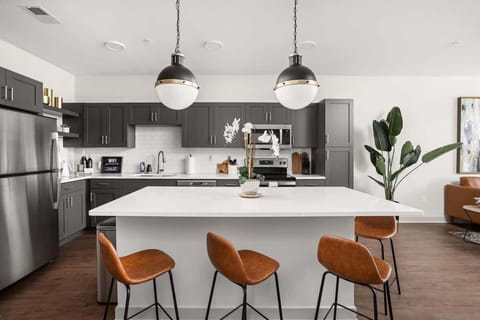 Pristine and modern kitchen space with bar seating for company