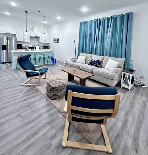 Large open concept first floor with plenty of seating and a smart tv.