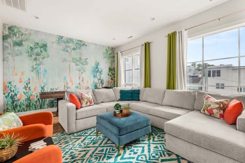 Comfortable and Colorful Living Space with a queen sleeper sofa, electric fireplace, and shuffle board!