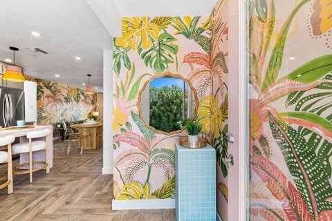 Eye-catching entry corner w/ bold mural, arched mirror & playful desert flair.
