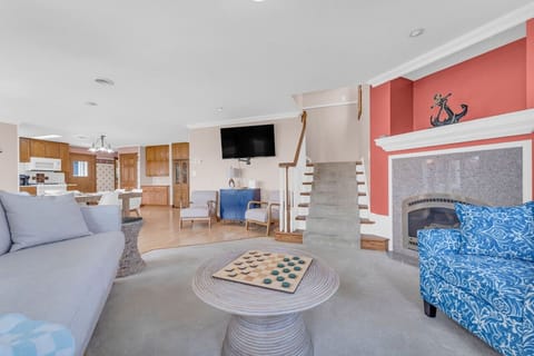 Main floor living room w ample seating and a TV to catch a flick when the weather isn`t cooperating