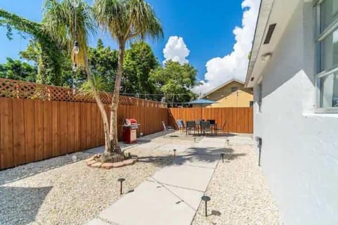 Relax and unwind in our delightful backyard area, featuring a spacious outdoor patio complete with comfortable seating.