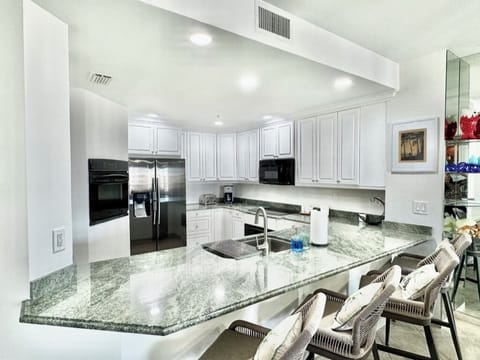 Fully stocked kitchen with counter seating for 4.