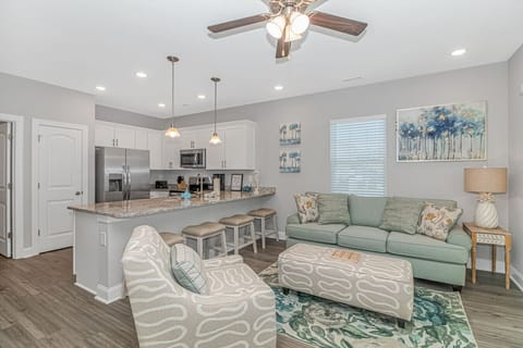 Spacious living area with full kitchen, island seating and comfortable lounge space ideal for groups