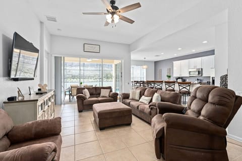 Spacious living room with plenty of comfortable sofas, perfect for relaxing and spending time with family and friends.