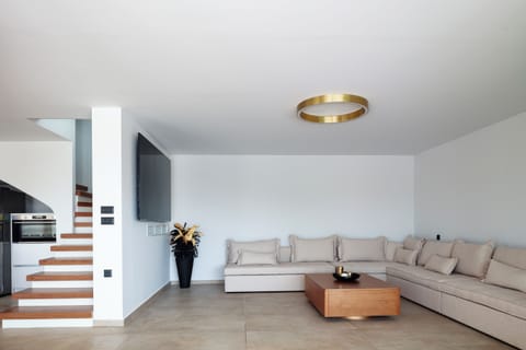 The living room boasts a sumptuous, oversized sofa, perfect for sinking into as you unwind, an impressive 86” TV, and a PlayStation 5 to enjoy all the fun!