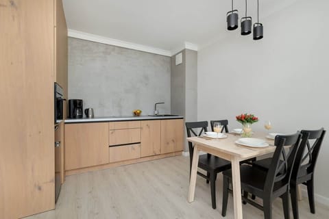 The sleek, fully equipped kitchenette with dining area.