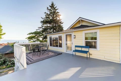 Bright private deck with outdoor seating, offering a peaceful space to unwind and enjoy the surroundings.