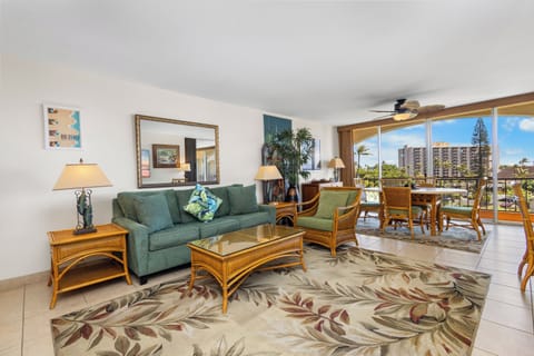 Relax in this bright, island-inspired living space where coastal charm meets comfort. Floor-to-ceiling windows frame tropical views and city skylines, filling your retreat with natural light and Hawaiian warmth.