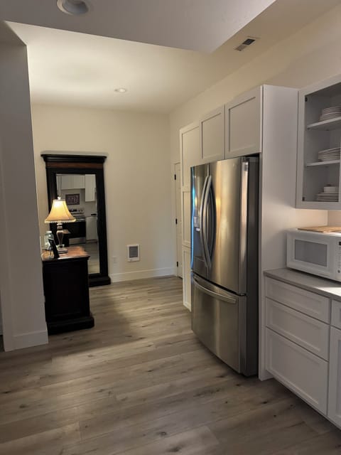 Kitchen and back hall with a full length mirror.