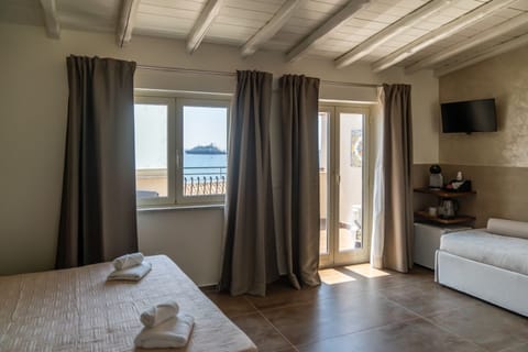 Panoramic Quadruple Room, Private Bathroom, Sea View | Premium bedding, minibar, individually decorated, individually furnished