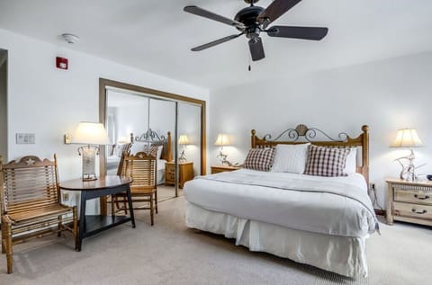 Relax in the spacious master bedroom, featuring a ceiling fan, comfortable bed, cozy decor, and ample natural light.