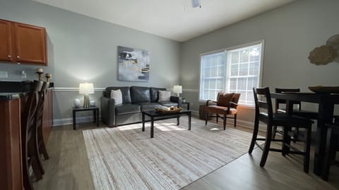 Relax and recharge in our cozy living room, where a comfy couch awaits your leisure!