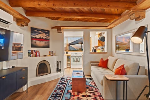 Living room, fireplace and kitchen, all in one open room.