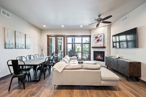 Spacious great room with comfortable sectional seating, large dining table, and plenty of natural light. The open layout makes it easy for everyone to gather, relax, and enjoy time together.