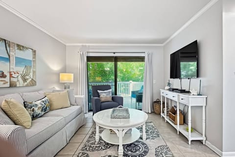 Relax in the comfortable living room featuring a new 55" Smart TV!