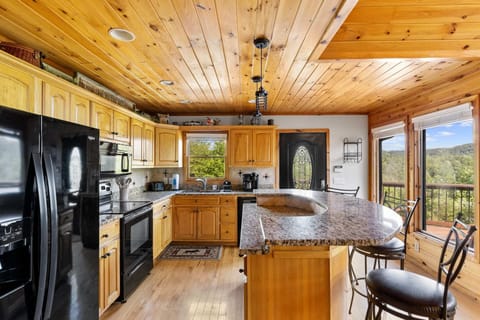 Cook and dine in style in our kitchen with warm wood cabinetry, elegant granite countertops, and large windows that frame stunning mountain views