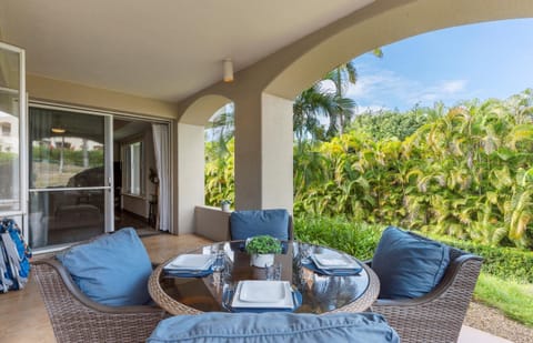 Your private covered terrace invites you to dine al fresco among tropical palms and lush greenery, where every meal feels like a peaceful escape.