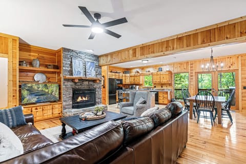 A cozy living area with a comfortable sectional sofa and a stone fireplace.
