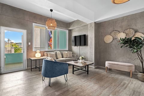 Living room with flat screen TV, access to balcony and comfortable seating