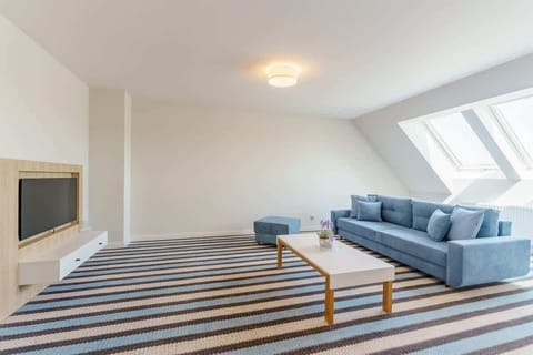 Relax in the stylish living room with a comfortable sofa and modern decor.