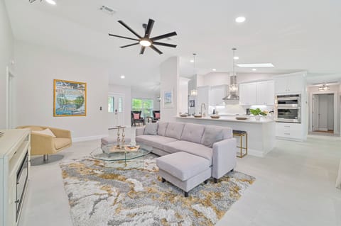 Bonita Vanderbilt - Living with electric fireplace and smart TV. Sliding doors open up to the screened in pool area