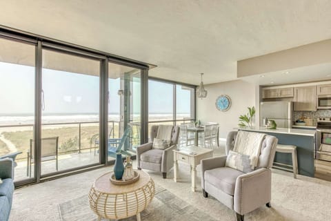 A modern, open-concept living space with large windows, cozy seating, a spacious dining area, and a bright, inviting atmosphere.
