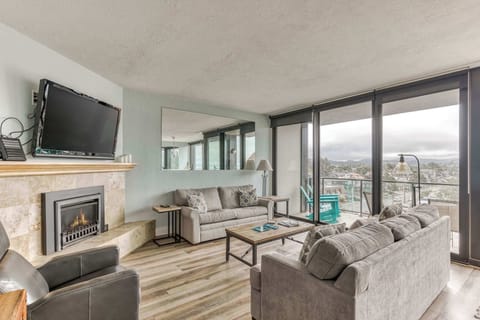 Relax in a bright, cozy living room with fireplace, big windows & comfy seating—your ideal home base for a beachfront getaway.