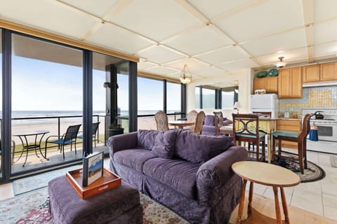 A modern, open-concept living space with large windows, cozy seating, a spacious dining area, and a bright, inviting atmosphere.