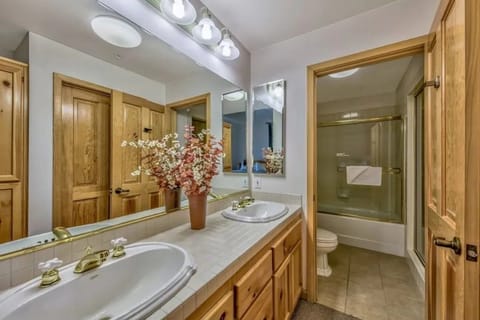 Freshen up in this bright bathroom, which includes a large vanity with ample counter space, a well-lit mirror, and a shower/tub combo.