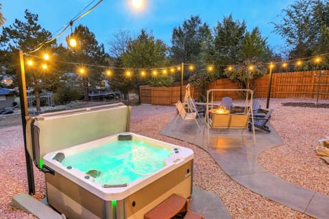 Glowing hot tub under warm string lights—step onto the gravel patio, grab a seat, and ease into an evening of fresh air and conversation as the sky settles into dusk.