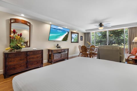 Your spacious retreat features a plush bed, tropical touches, and a private balcony overlooking lush greenery—perfect for unwinding after a day of island adventures.