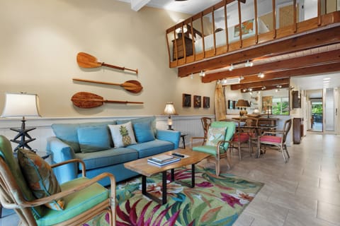 Relax in this airy coastal retreat with vaulted ceilings, exposed beams, and tropical decor. Comfortable seating and charming nautical accents create your perfect island escape.