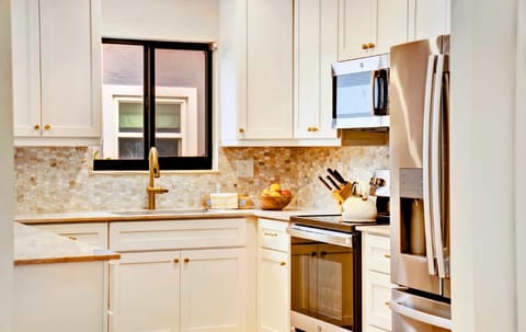 Sleek kitchen, stainless steel appliances! Culinary magic awaits.
